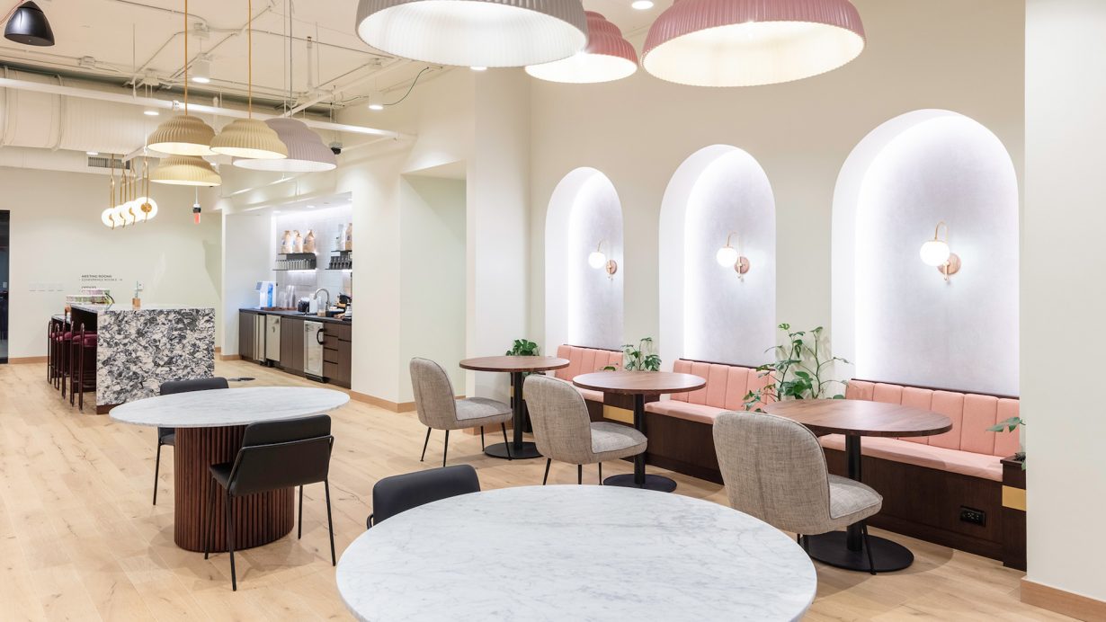 A soft pink color palette adds a pop of color to the common spaces.