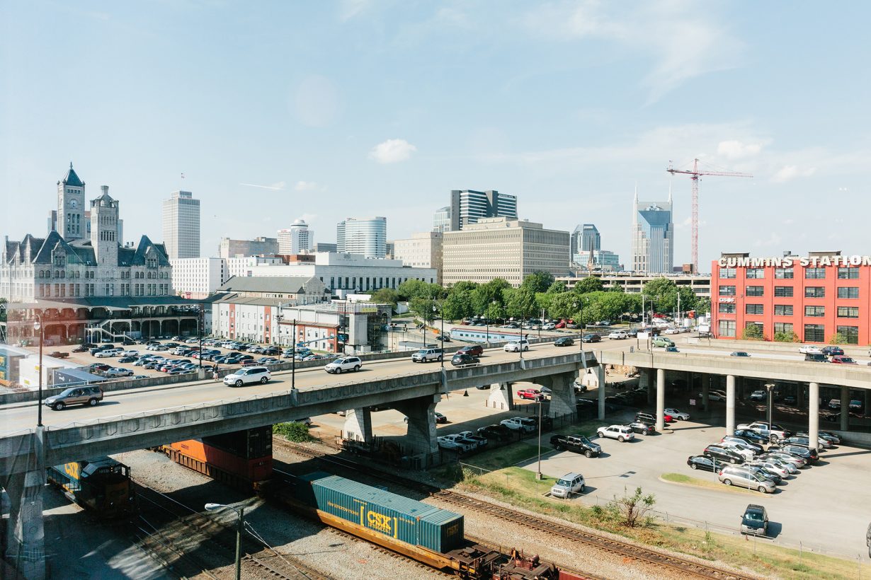 Floor-to-ceiling windows provide panoramic views of downtown Nashville.