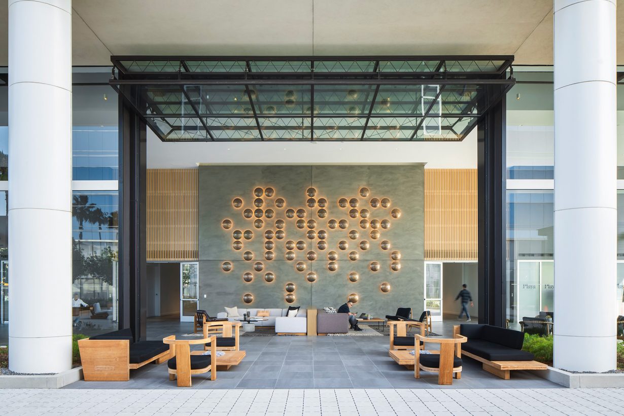Chic artwork, plush furnishings, and glass details create an inviting lobby that’s perfect for casual meetings or breaks throughout the day.