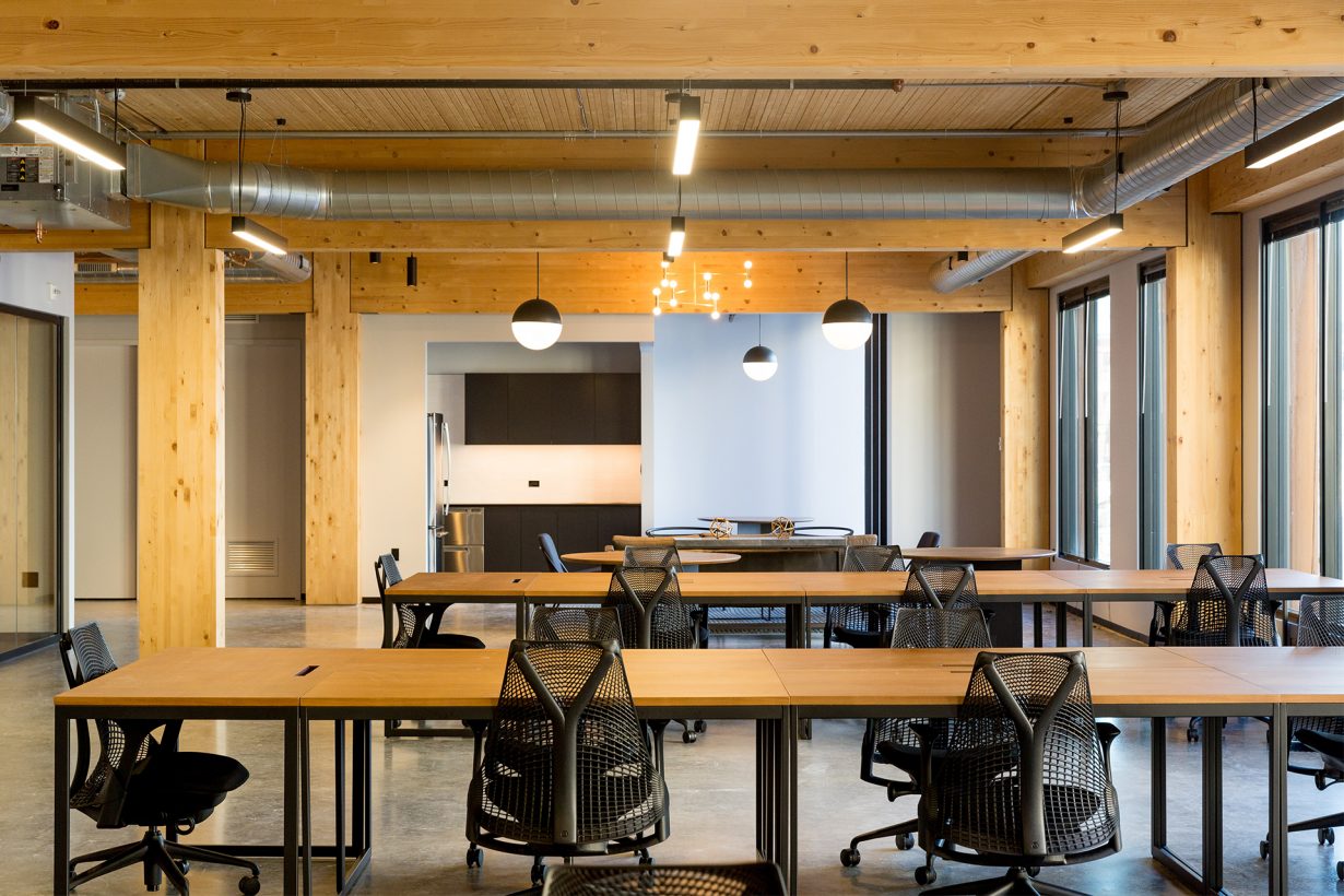 Details like illuminated wood ceilings and sleek light fixtures add warmth to the space.