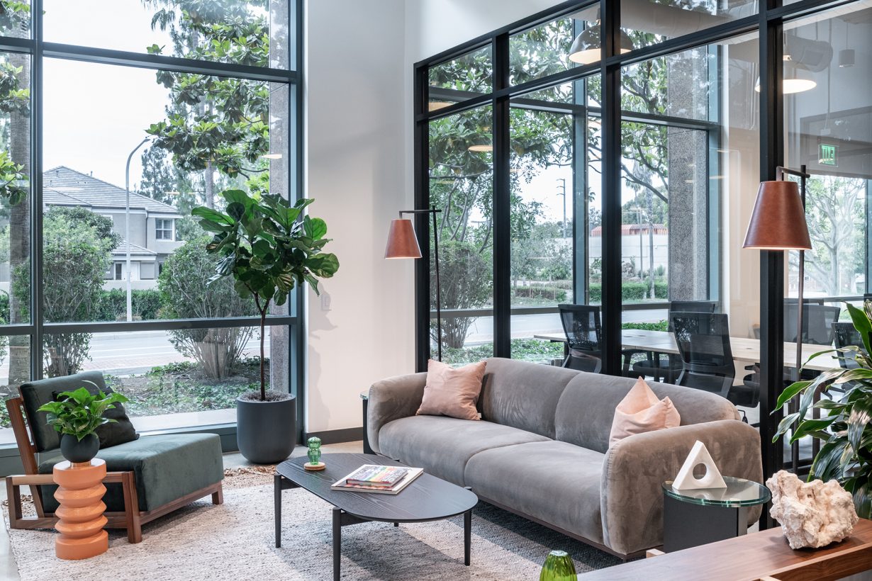 Large floor-to-ceiling windows let the outside in at Industrious Newport Beach.