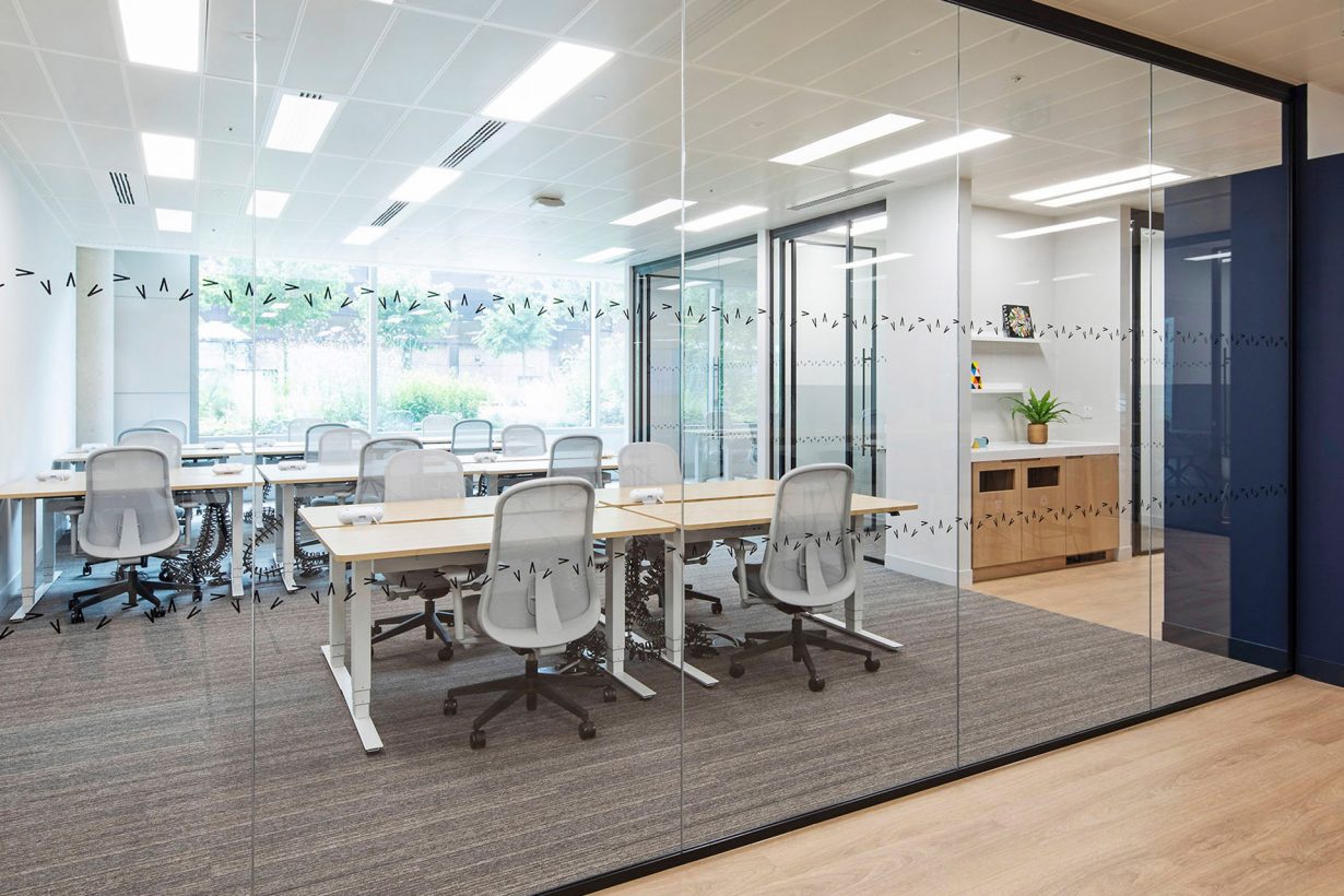 Floor-to-ceiling windows in this suite at Hana by Industrious at 245 Hammersmith let in tons of natural light.