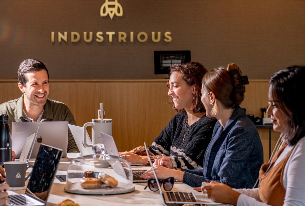 team working around a table at an Industrious office