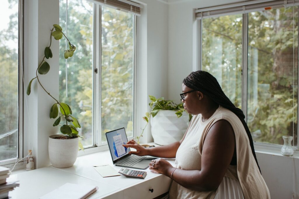Woman working remotely on a laptop, illustrating a virtual office setup