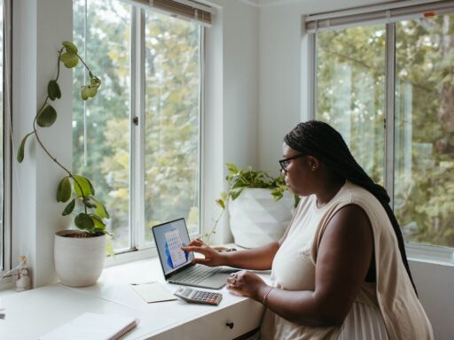Woman working remotely on a laptop, illustrating a virtual office setup